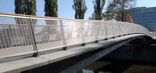 Bridge cladding with stainless steel wire mesh with light reflection.