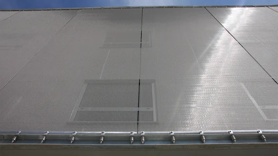 Facade cladding with metal mesh sun protection mesh