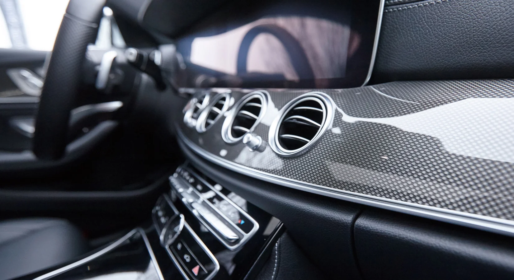 Trim with design mesh Trim in the vehicle interior with design mesh.