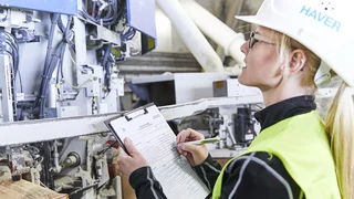A service technician noting machine data