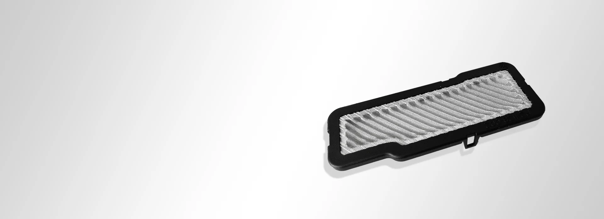 Wire mesh piece with plastic overmoulding and pleated woven wire cloth Wire mesh piece with plastic overmoulding and pleated woven wire cloth