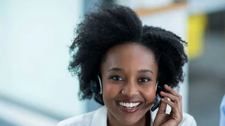 Woman with a headset answering a hotline call.