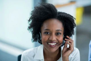 Woman with a headset answering a hotline call.