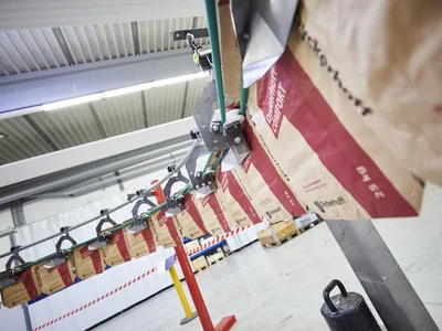 HAVER & BOECKER PATHFINDER automatisiertes Sackhandhabungssystem, das leere Säcke von RADIMAT zu ROTO-PACKER in einer vollautomatischen Verpackungslinie transportiert.