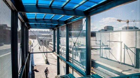 View of the station through a facade cladding made of sun protection mesh