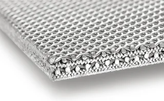 A cross-section of a fabric laminate shows the individual fabric layers being sintered.