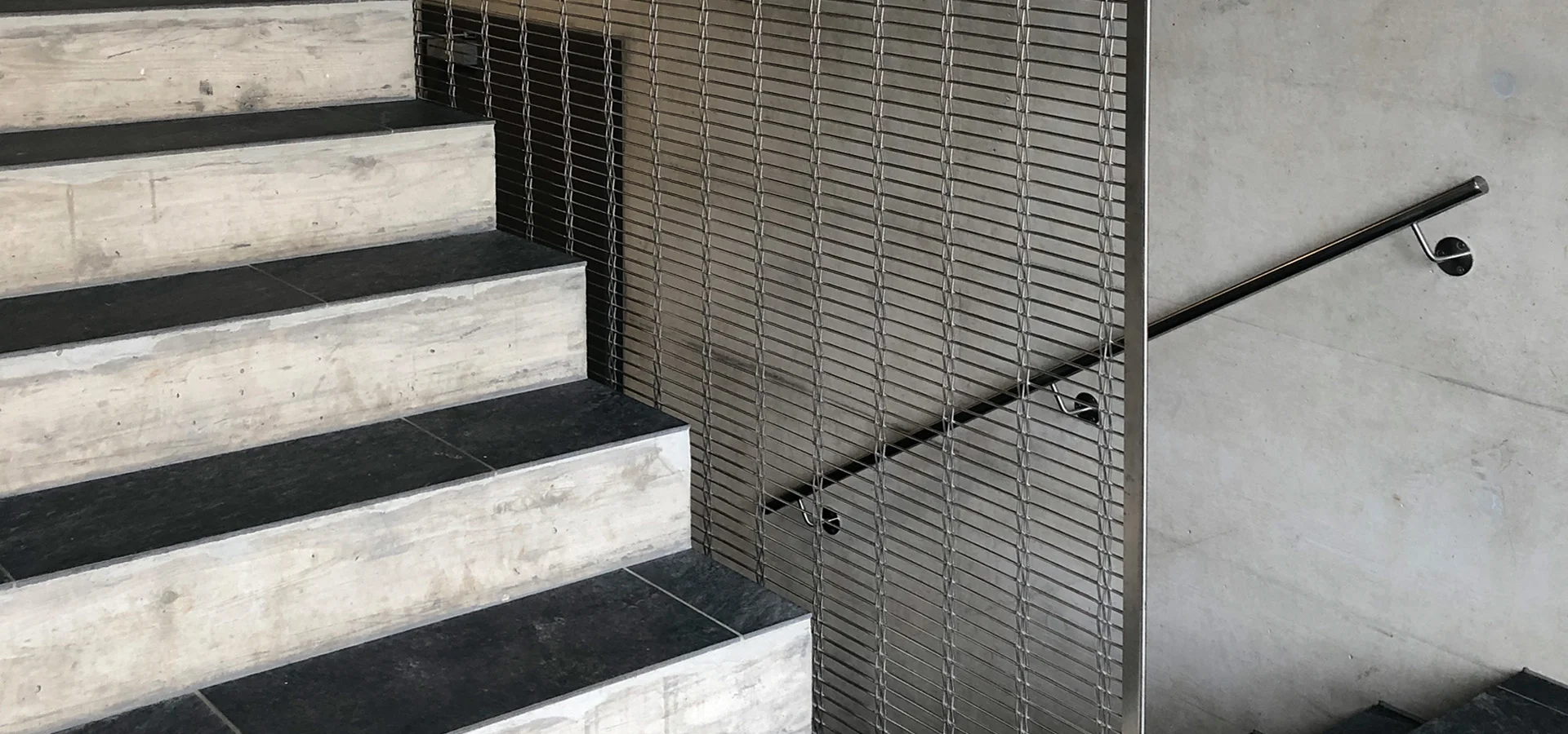 Cladding of a staircase with HAVER architectural mesh Cladding of a staircase with HAVER architectural mesh